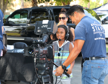 child with RiversideTV staff