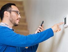 Person adjusting thermostat